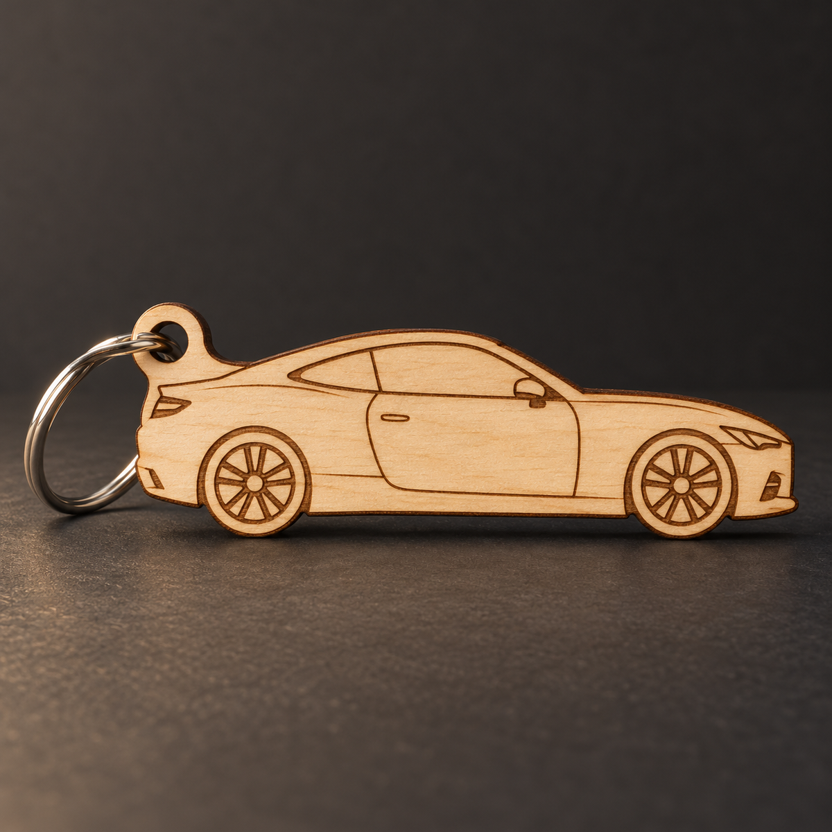 Sport Coupe Key Fob in Birch Ply with brown laser engraved details; illustrative rendering
